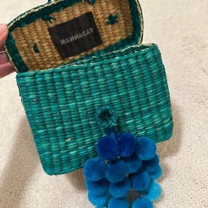 Nannacay blue straw bag with pom poms
